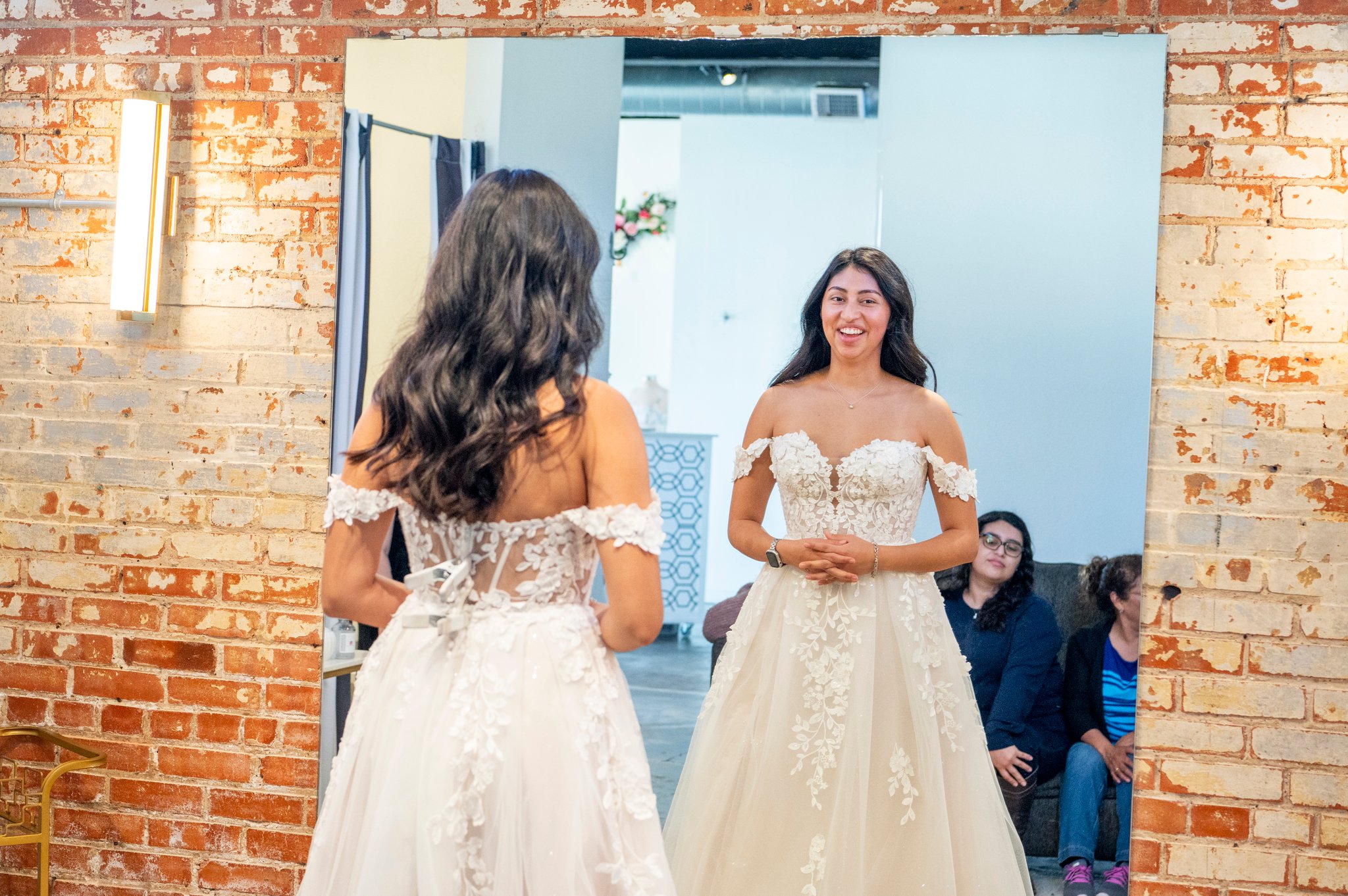 Bride trying on wedding dresses during her Bliss Bridal appointment