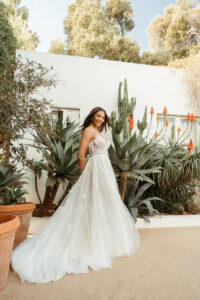 Stella York wedding dress style SY8153 featuring 3D floral lace, sheer bodice, and tiered tulle ballgown skirt