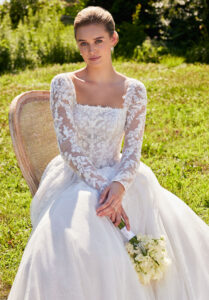 Seattle wedding dress by Morilee, style 2714, featuring a crescent neckline, beaded lace bodice, A-line skirt, and detachable illusion sleeves