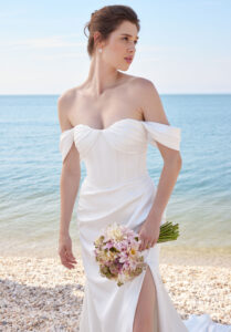 Sherie wedding dress by Morilee featuring a draped satin sheath silhouette, corset bodice, and detachable off-the-shoulder sleeves