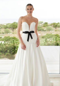 Simone wedding dress by Morilee featuring a strapless sweetheart neckline, drop waist satin ballgown, and detachable bow belt