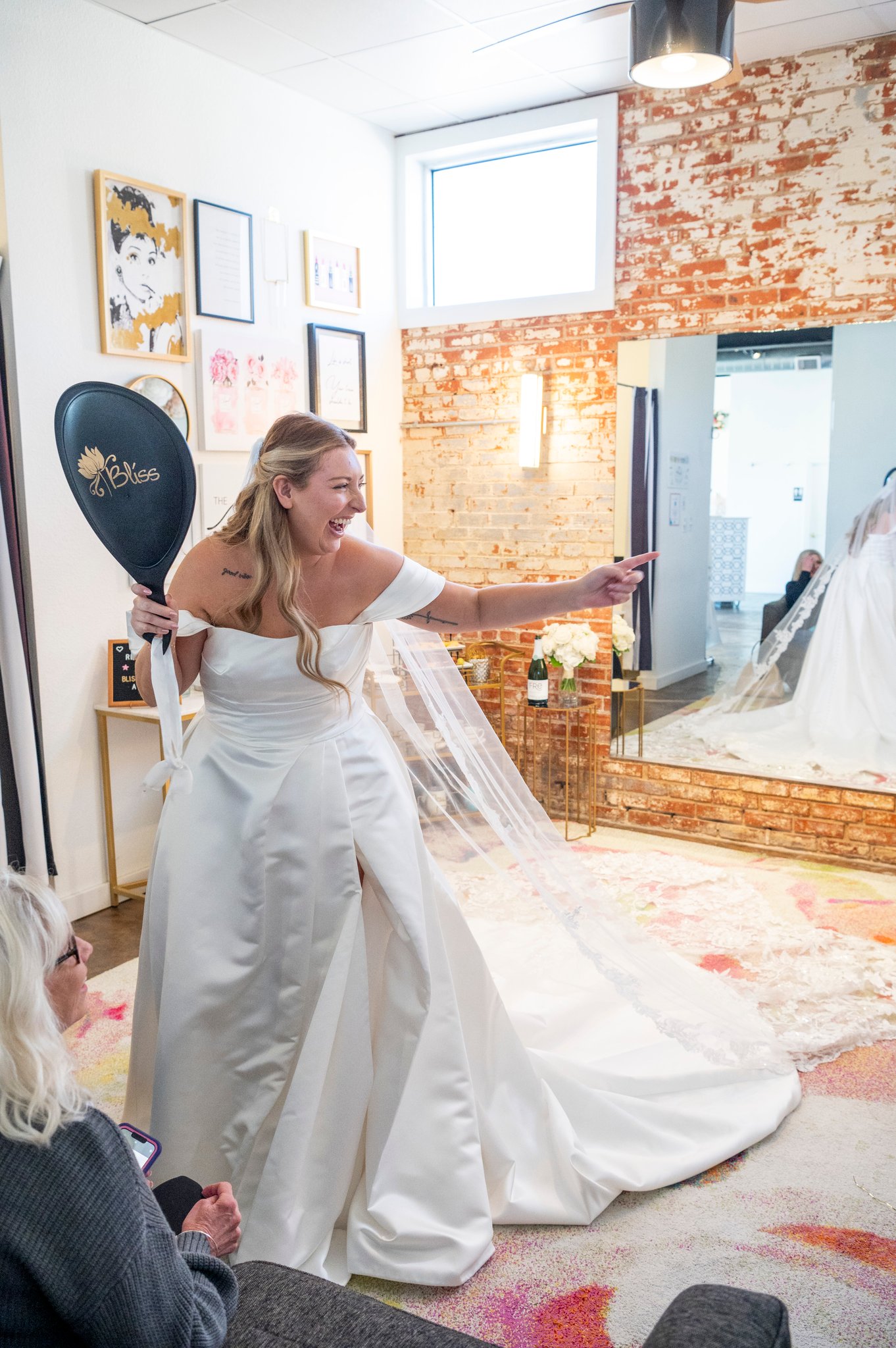 Bride trying on designer wedding dresses at Bliss Bridal Salon